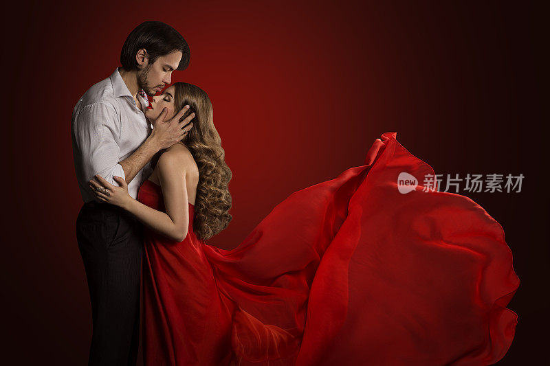 接吻的情侣，年轻的男人亲吻女人，红色的裙子，飘扬的织物，爱