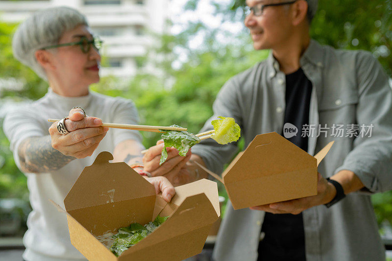 亚洲老年夫妇利用闲暇时间一起吃午餐。