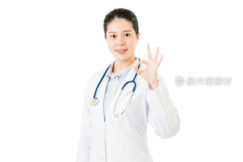 微笑的亚洲女医生与听诊器显示ok手势