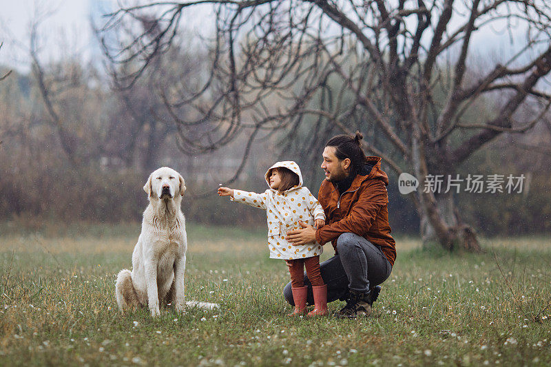 年轻的父亲和他的女儿和一只狗