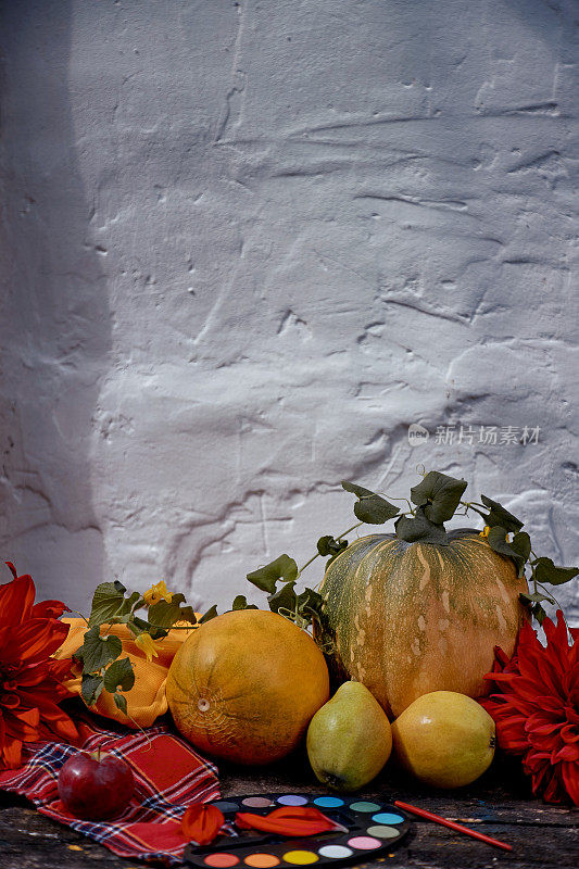 色彩斑斓的美展:黄色的水果和蔬菜和明亮的绘画与画笔，南瓜，梨，苹果和瓜。感恩节的概念。秋天的静物与红色的georgine，现代的影子