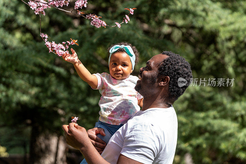 小女孩和爸爸在春天的公园里