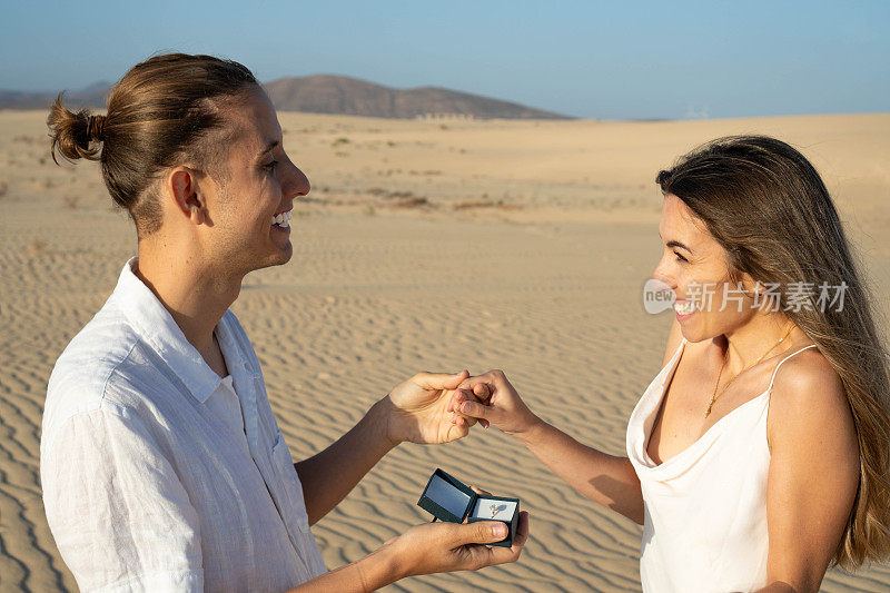 与幸福的情侣在海滩浪漫求婚