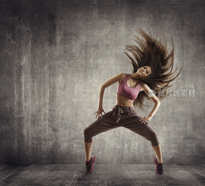 健身运动舞蹈，女舞者飞扬的头发跳舞在混凝土上