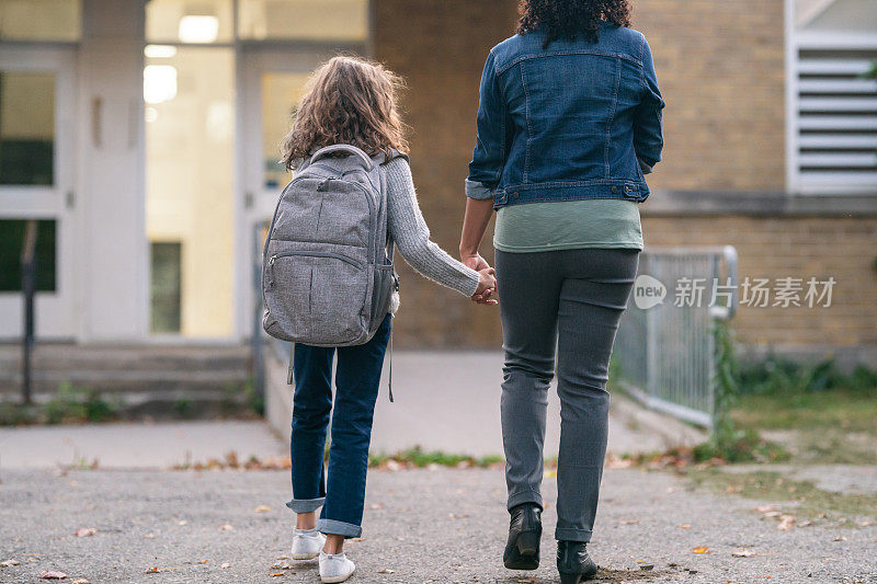 妈妈牵着女儿的手去上学