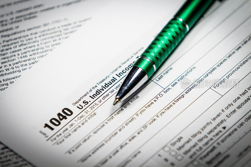 美国税单1040与笔和计算器。税收的形式