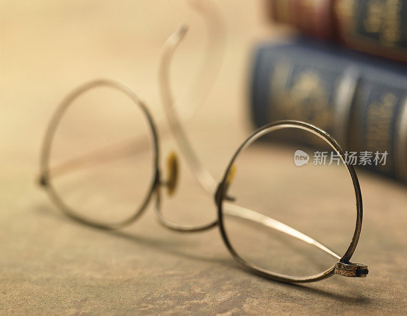 古董眼镜和皮革装订的书