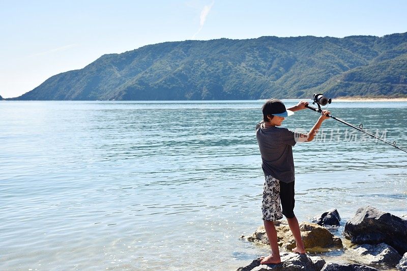 在海边钓鱼的小男孩