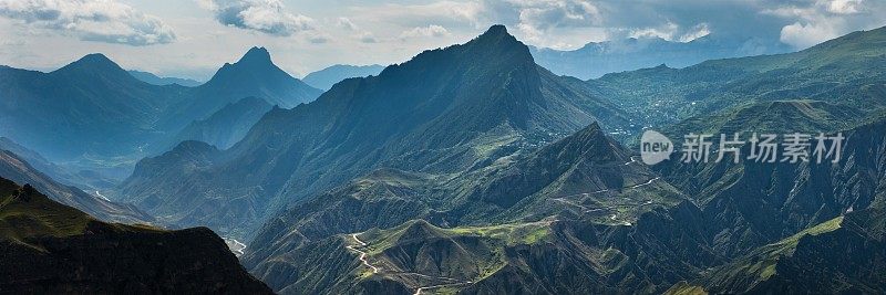 高加索山脉雄伟的峰顶。达吉斯坦阴天下的青山绿水。全景照片