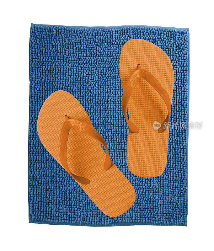蓝色地毯上的一双橙色拖鞋