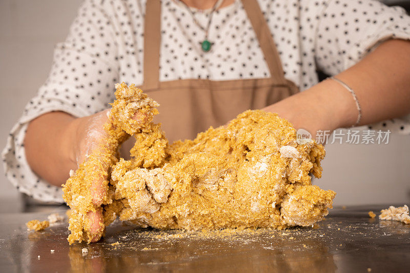 一名女子正在准备用藜麦制成的素食汉堡