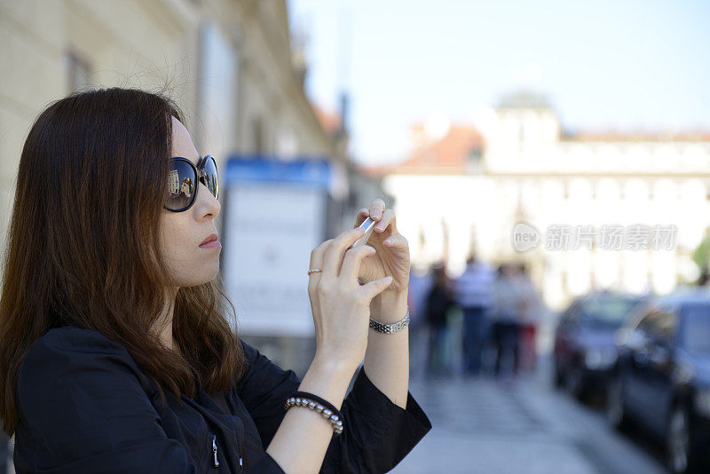 布拉格一名女游客用手机拍照