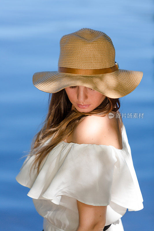 夏天在海滩附近戴着草帽的女人