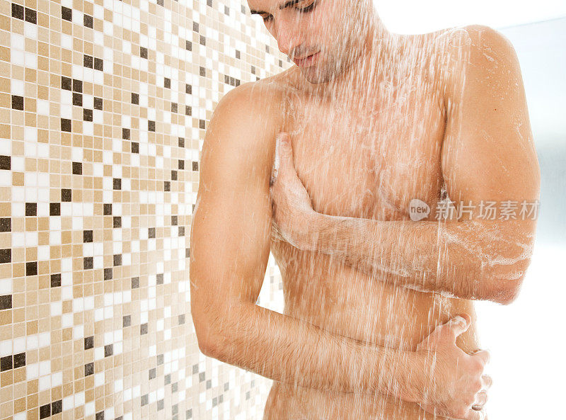 年轻英俊的男人在洗澡。