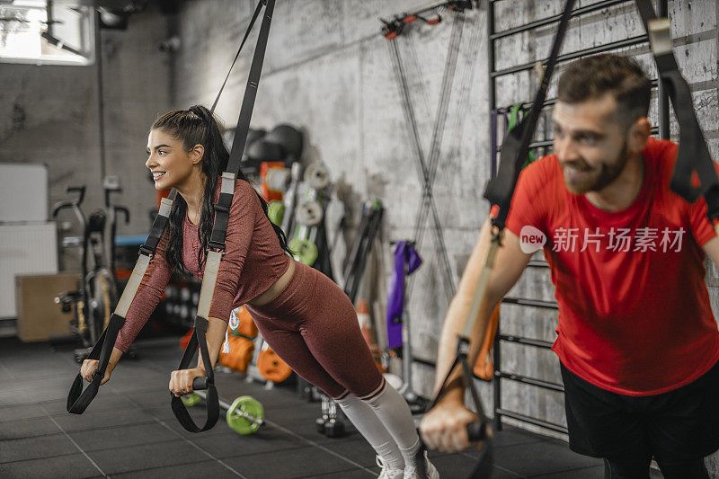 男人和女人有运动训练和练习吊带在健身房