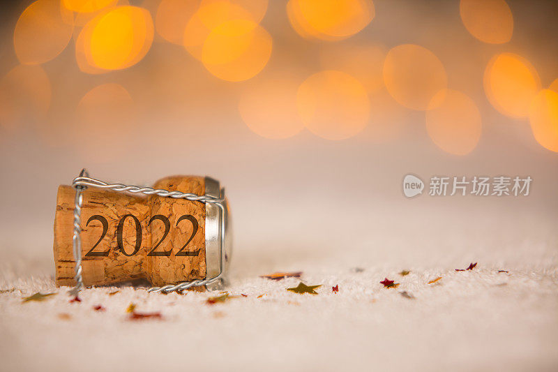 雪上的星星形状和软木塞祝2022年新年快乐