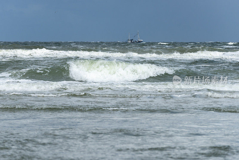 德国，下萨克森州，东弗里斯兰，尤利斯特，暴风雨的海面上有渔船。