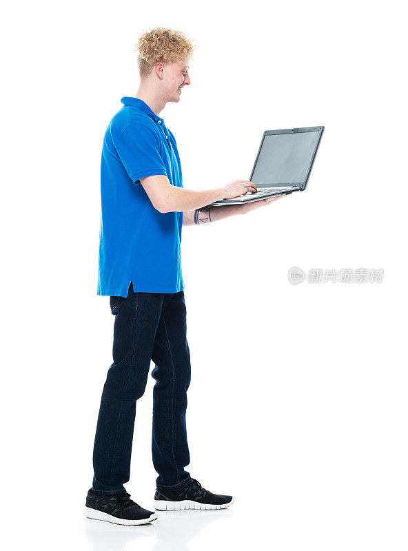 白人男性穿着polo衫站在白色背景前使用电脑