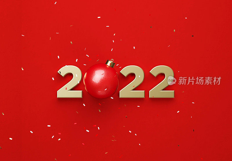 金色的2022和红色的圣诞装饰形成了2022在坠落的五彩纸屑下的红色背景