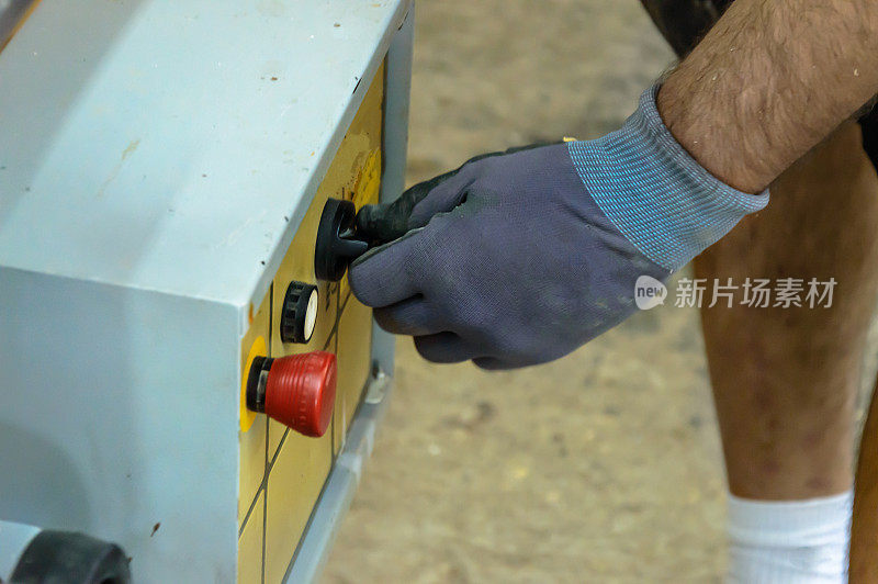 一位经验丰富的木匠在木工车间分析冲床。
