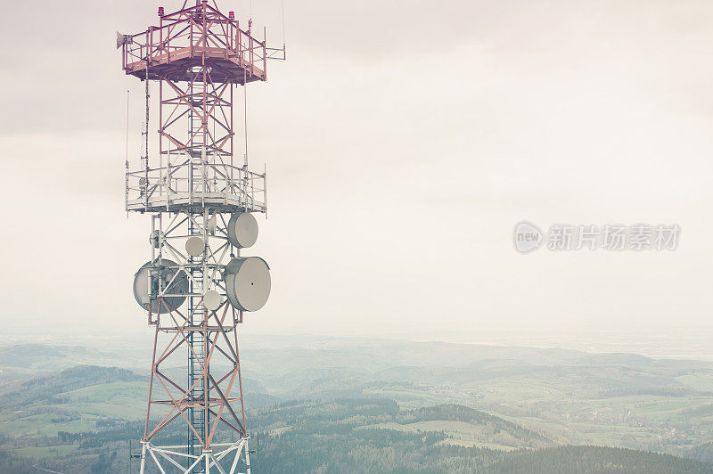 多云的山谷背景上的无线电桅杆