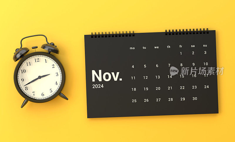 黄色背景上的闹钟和2024年11月日历