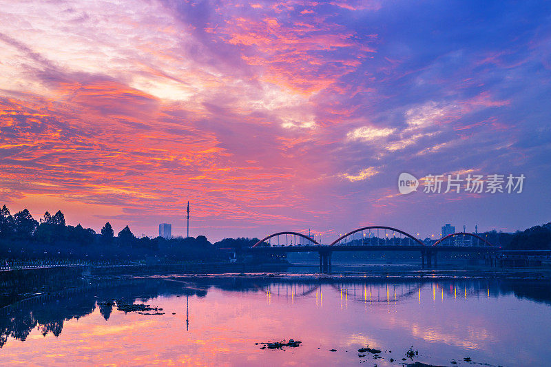 日落时分，现代城市在河边的城市景观和天际线