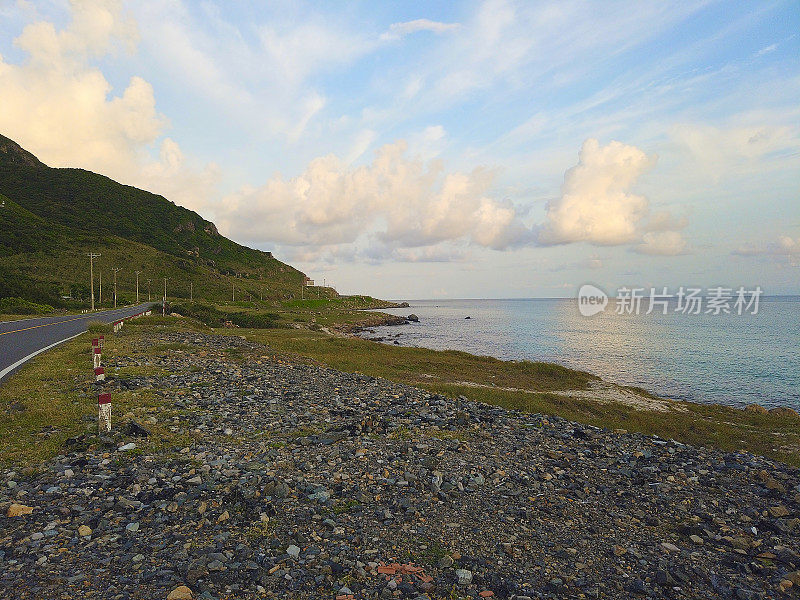 越南孔岛的空旷蜿蜒的乡村公路全景。日落时的汽车旅行。蓝天，云和山。Condao岛屿。