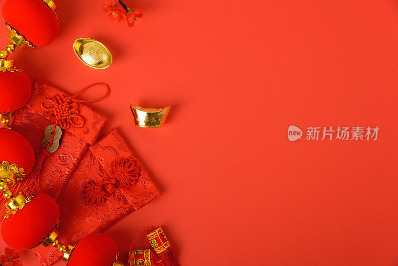 春节喜庆概念，平铺俯视图，喜庆春节用红包和金元宝在红色背景上