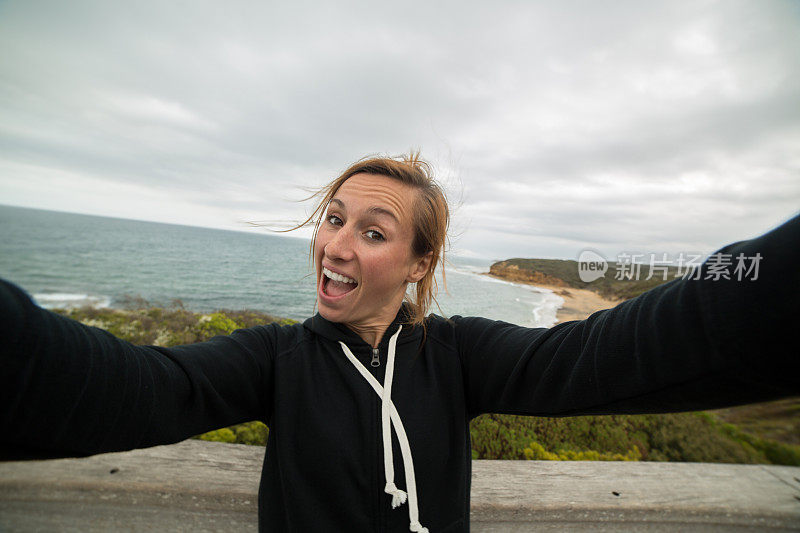 一名女孩沿着大洋路钟海滩拍自拍照