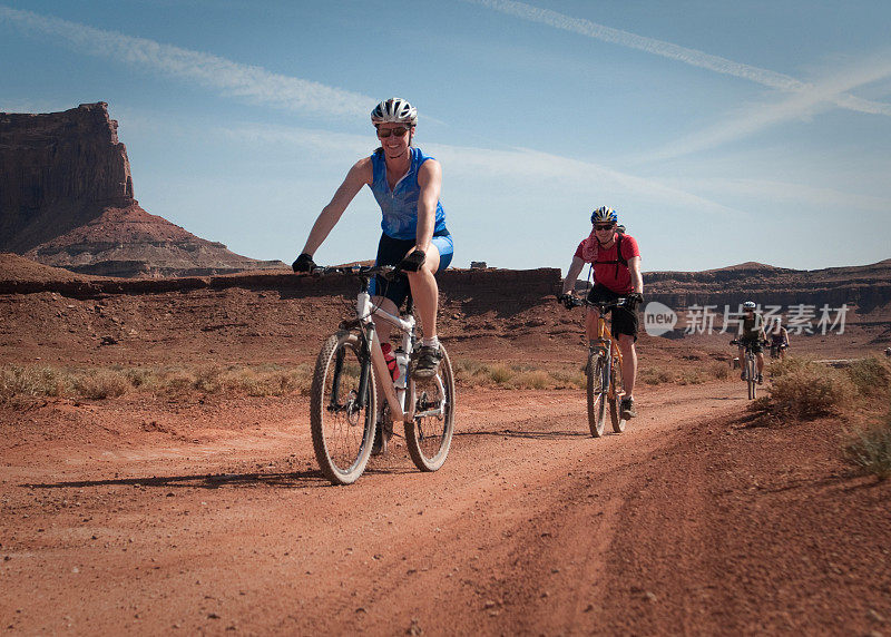 四个人在沙漠山地自行车。