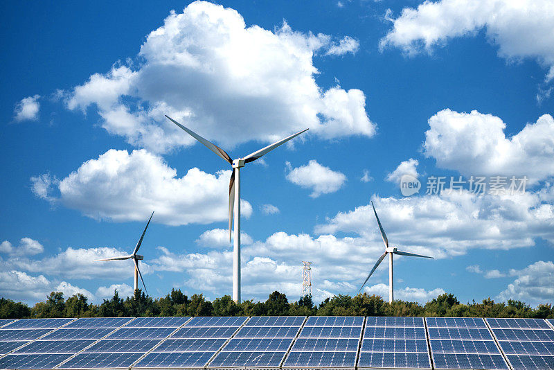 平原地区的太阳能发电站，巨大的蓝色太阳能电池板和巨大的风力涡轮机。
