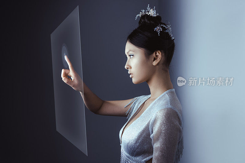 未来的概念。年轻漂亮的亚洲女人触摸数字全息图