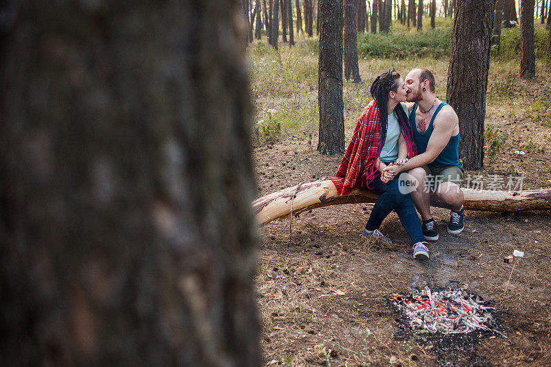 情侣爱自然野餐篝火森林概念。