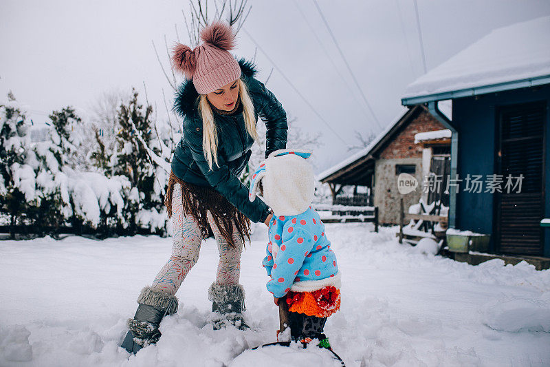 快乐的妈妈喜欢和她的孩子在雪地里玩