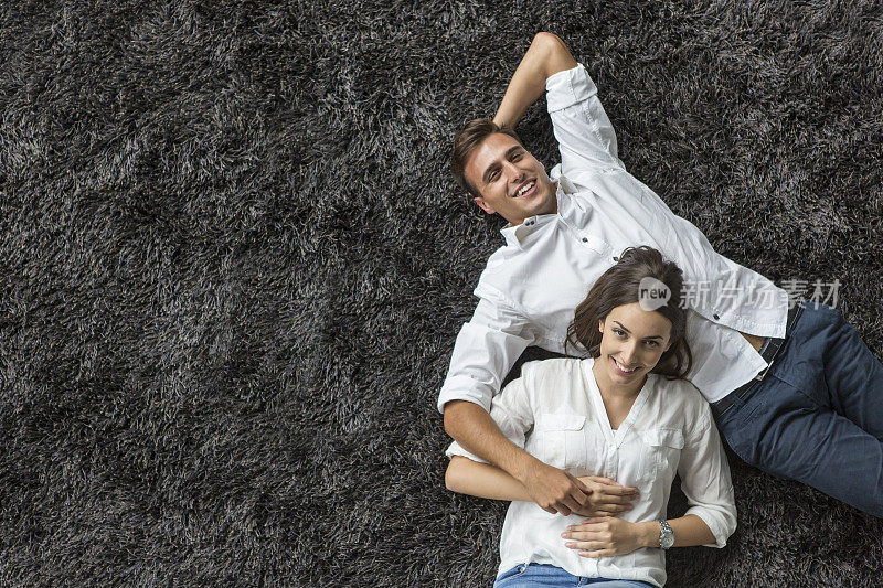 一对年轻夫妇在地毯上休息