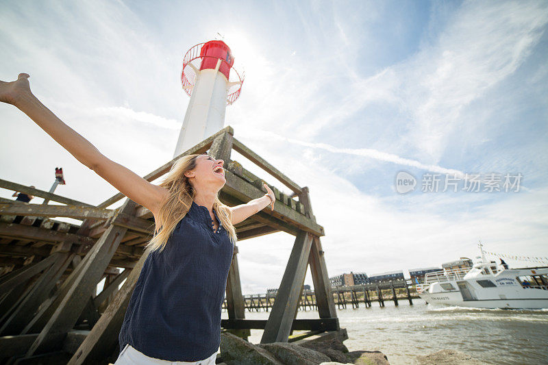 在灯塔-诺曼底-法国，欢呼的妇女向大海张开双臂