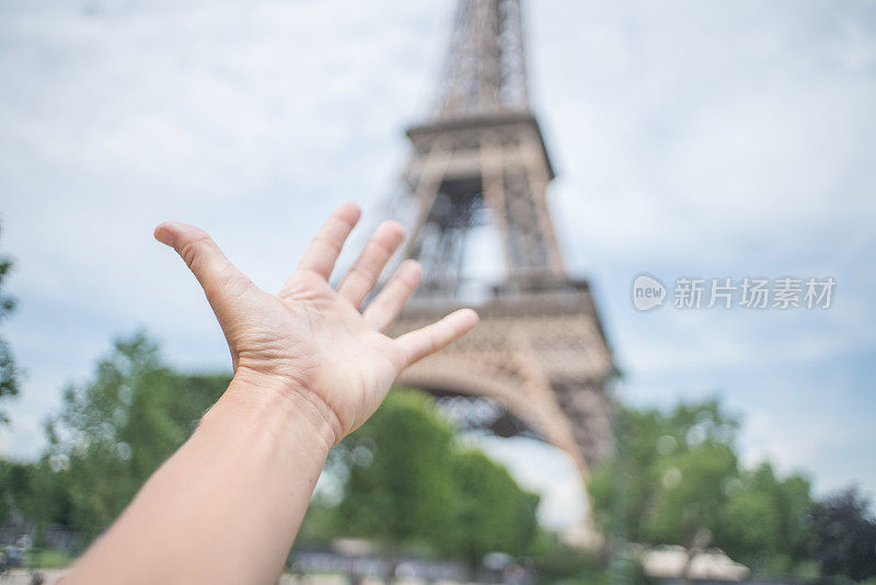 法国巴黎，手伸向埃菲尔铁塔的细节