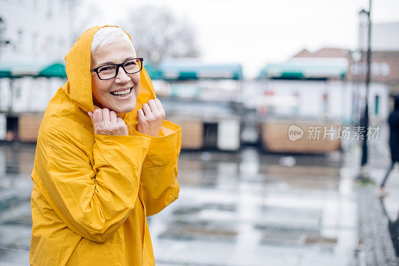 穿着黄色雨衣的可爱老年女性