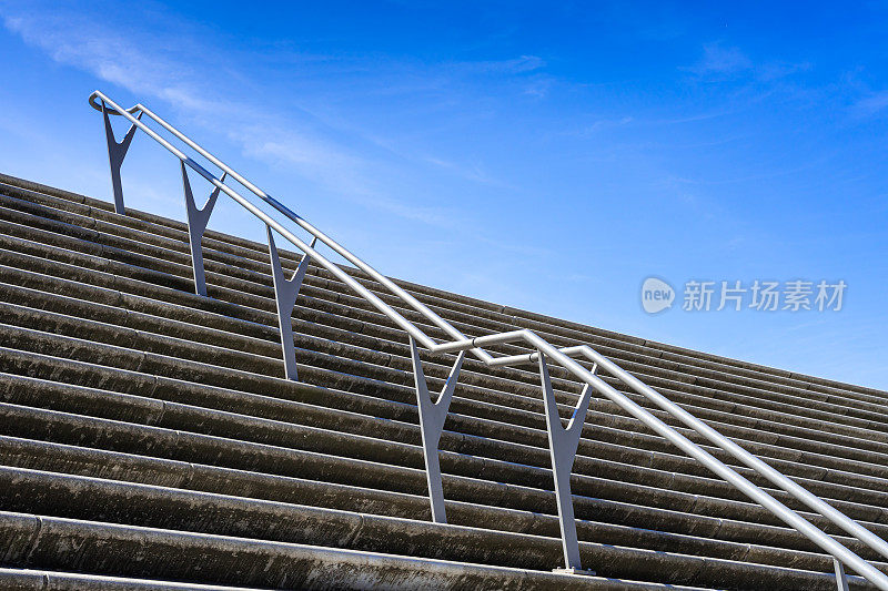 低角度的楼梯和栏杆对着晴朗的天空