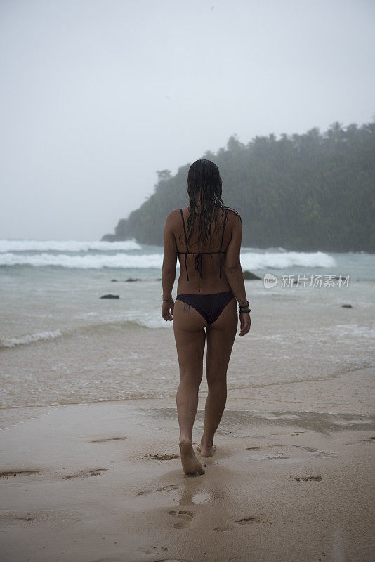 斯里兰卡，一名女子在雨中享受海滩度假
