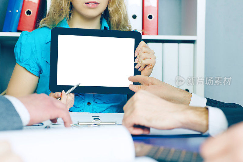 商务女性向办公室同事展示电子平板电脑。