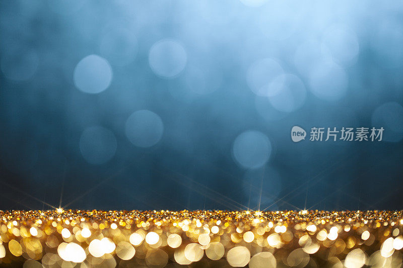 金色闪光和蓝色散焦灯-圣诞节，节日，庆祝背景