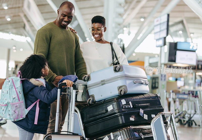 一个非洲家庭站在机场拿着行李