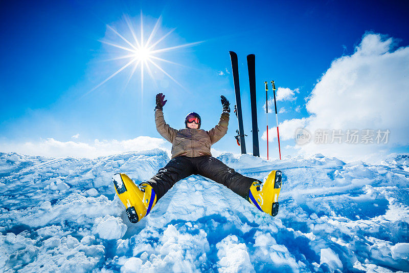 快乐的高山滑雪者坐在山顶上