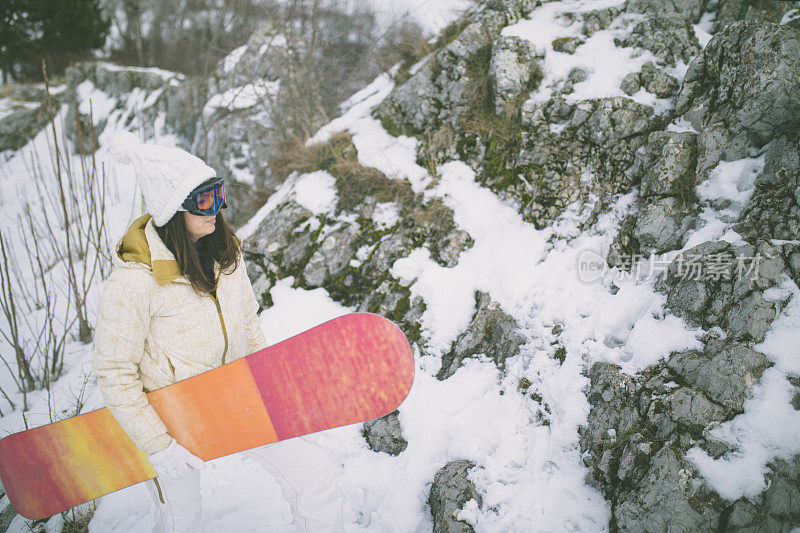 冬天穿着滑雪服的女人靠近滑雪板