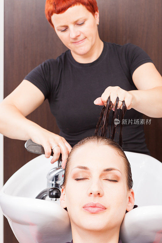 理发师为染后的妇女洗头发