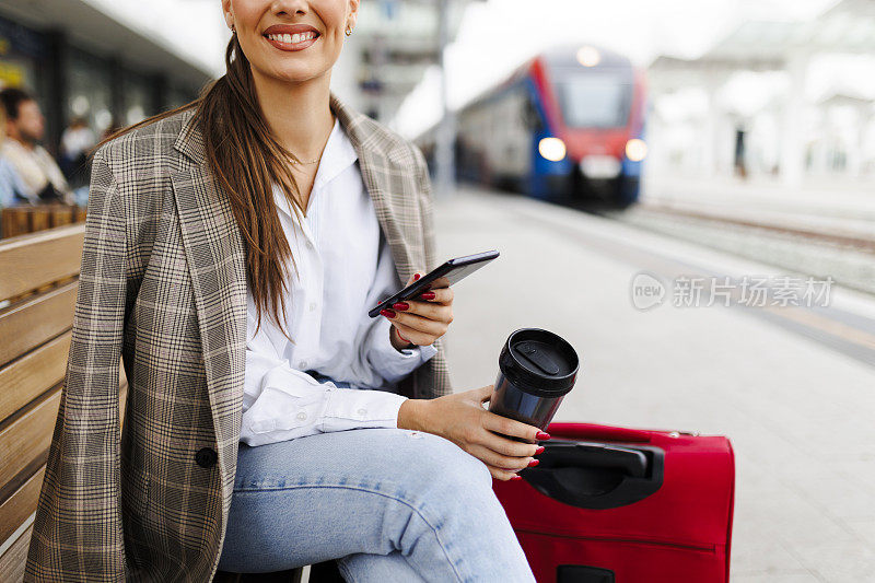 女乘客在火车站使用电话。旅行和积极的生活方式理念。乘火车旅行
