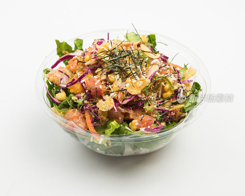 用玻璃碗里的紫色卷心菜、肉、玉米和切片蔬菜做成的沙拉特写