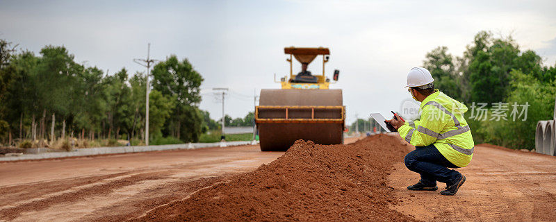 亚洲土木工程师检查道路施工改善基地道路施工红土。振动压路机附近各层红土填埋检查。